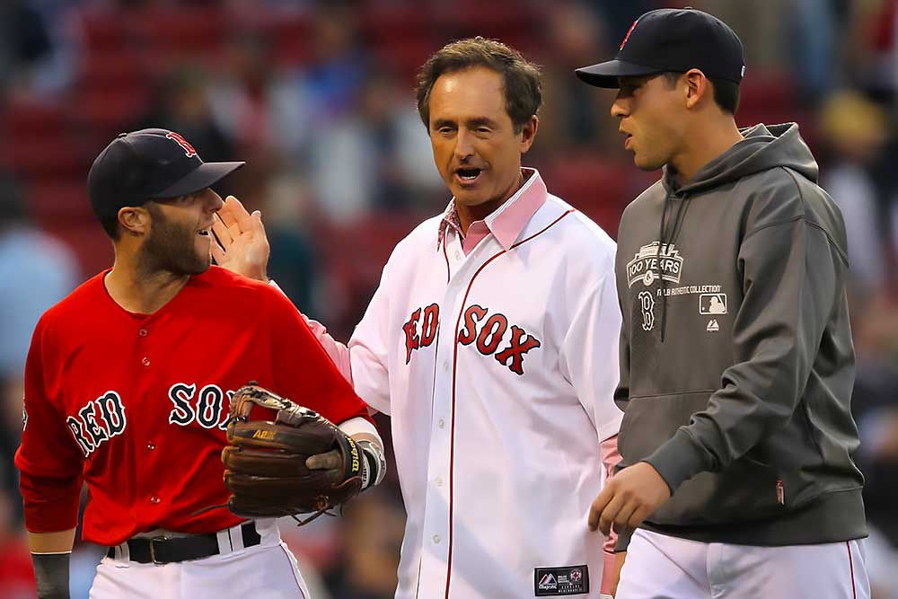 Fred Lynn, a baseball legend and former center fielder for the Boston Red Sox, chats with two players on the field. Lynn, in a Red Sox jersey, shares a moment at Fenway Park, capturing his iconic presence in Major League Baseball.| Fredlynn.com | Official Home of Fred Lynn